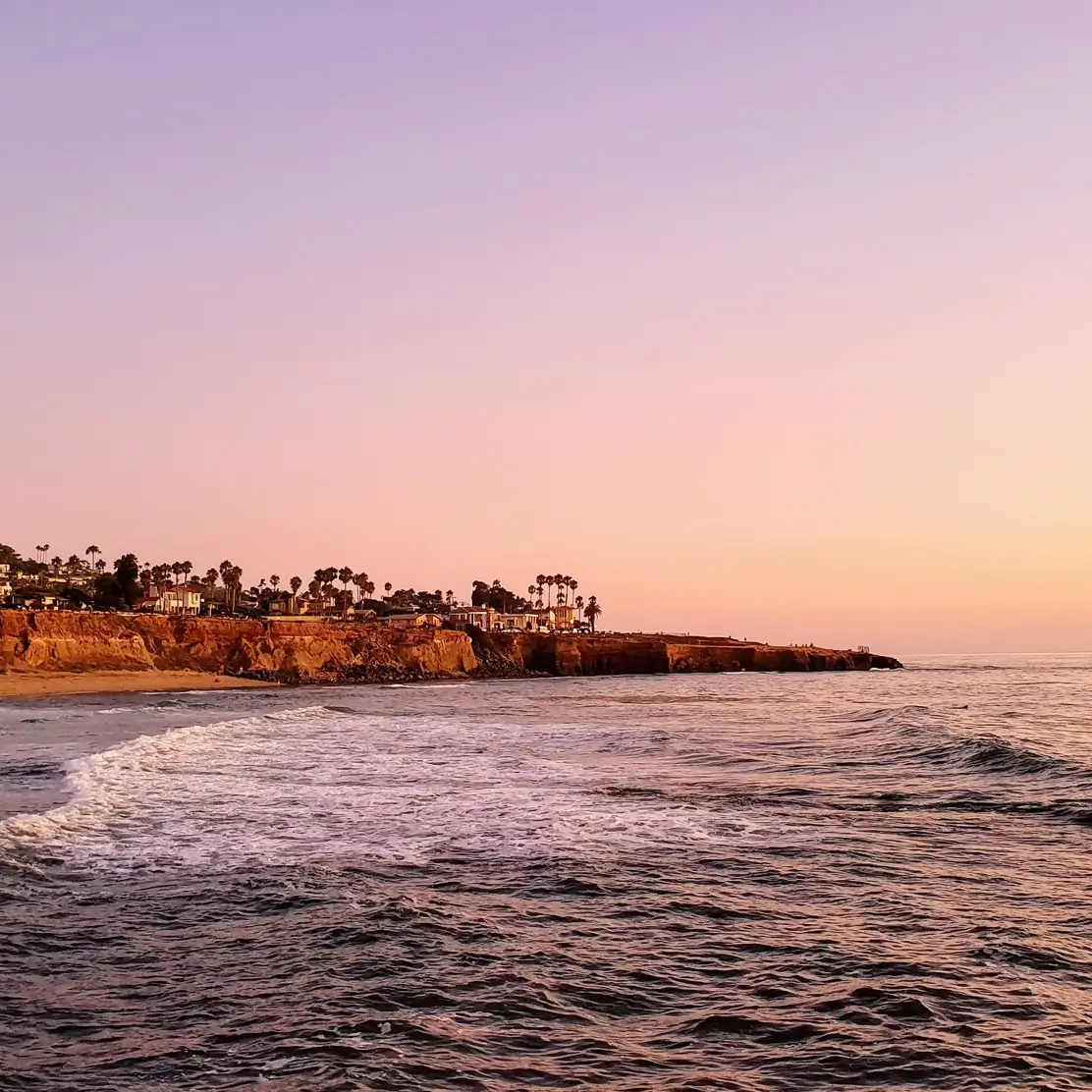 A sunset view of Sunset Cliffs from the Pacific Ocean.