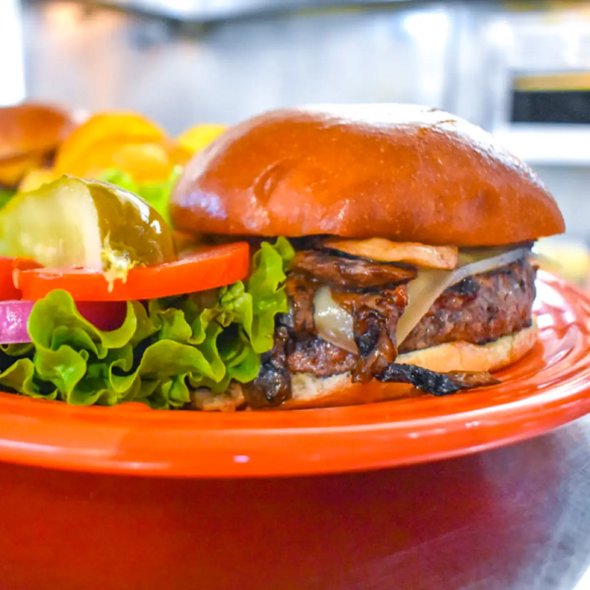 A cheeseburger dish with fries and salad from Crest Cafe. 