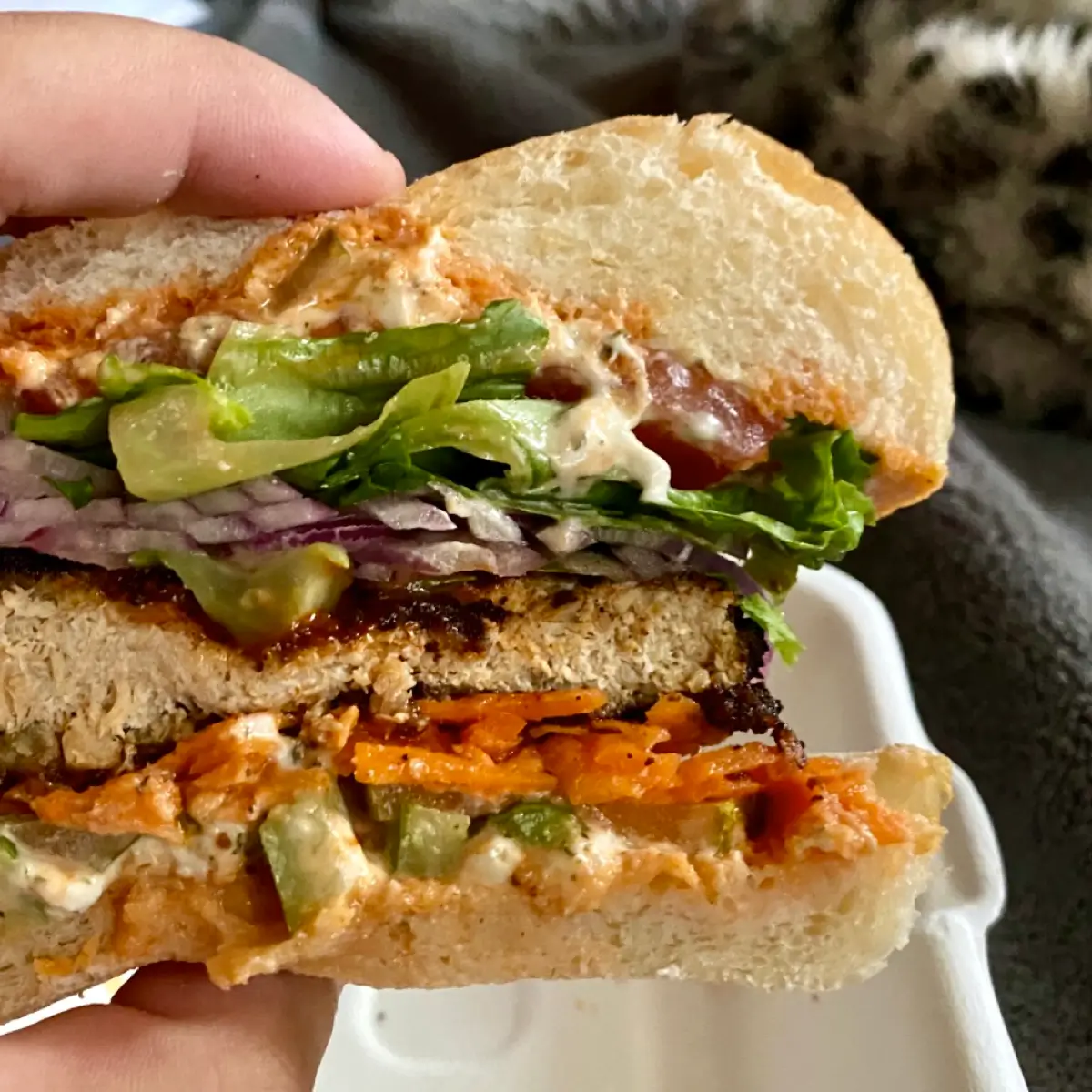 A grilled chicken sandwich with fresh vegetables from Evolution. 