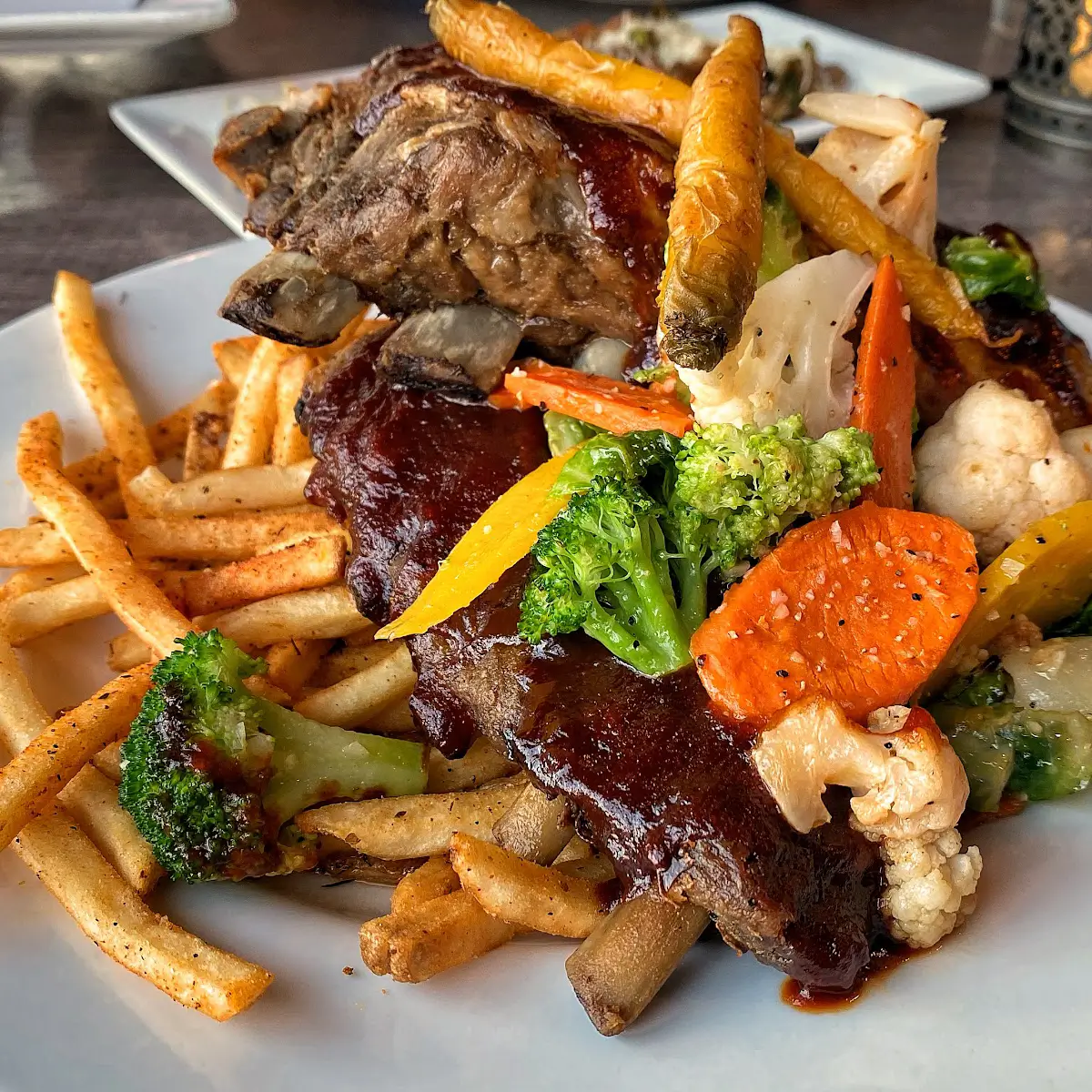 Steak with grilled vegetables and fries with sauce at Harley Grey. 