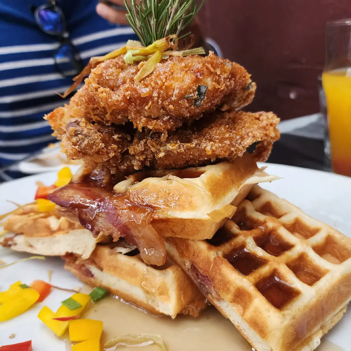 Fried chicken and waffles with syrup and bacon from Hash House A Go Go.