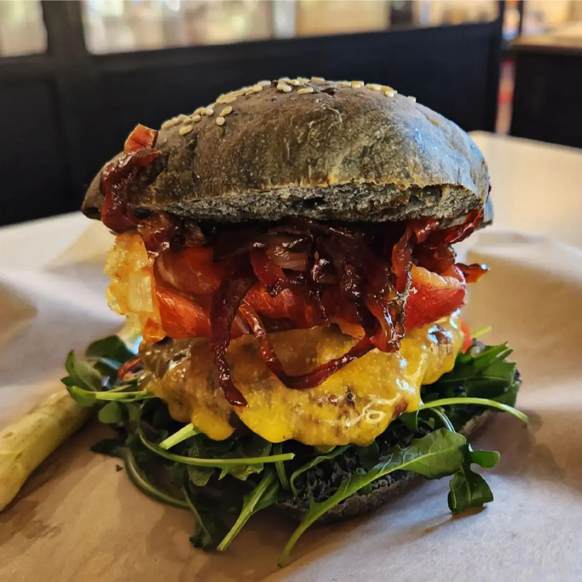 A black bun burger with cheese from Kafe at the Abpopa.
