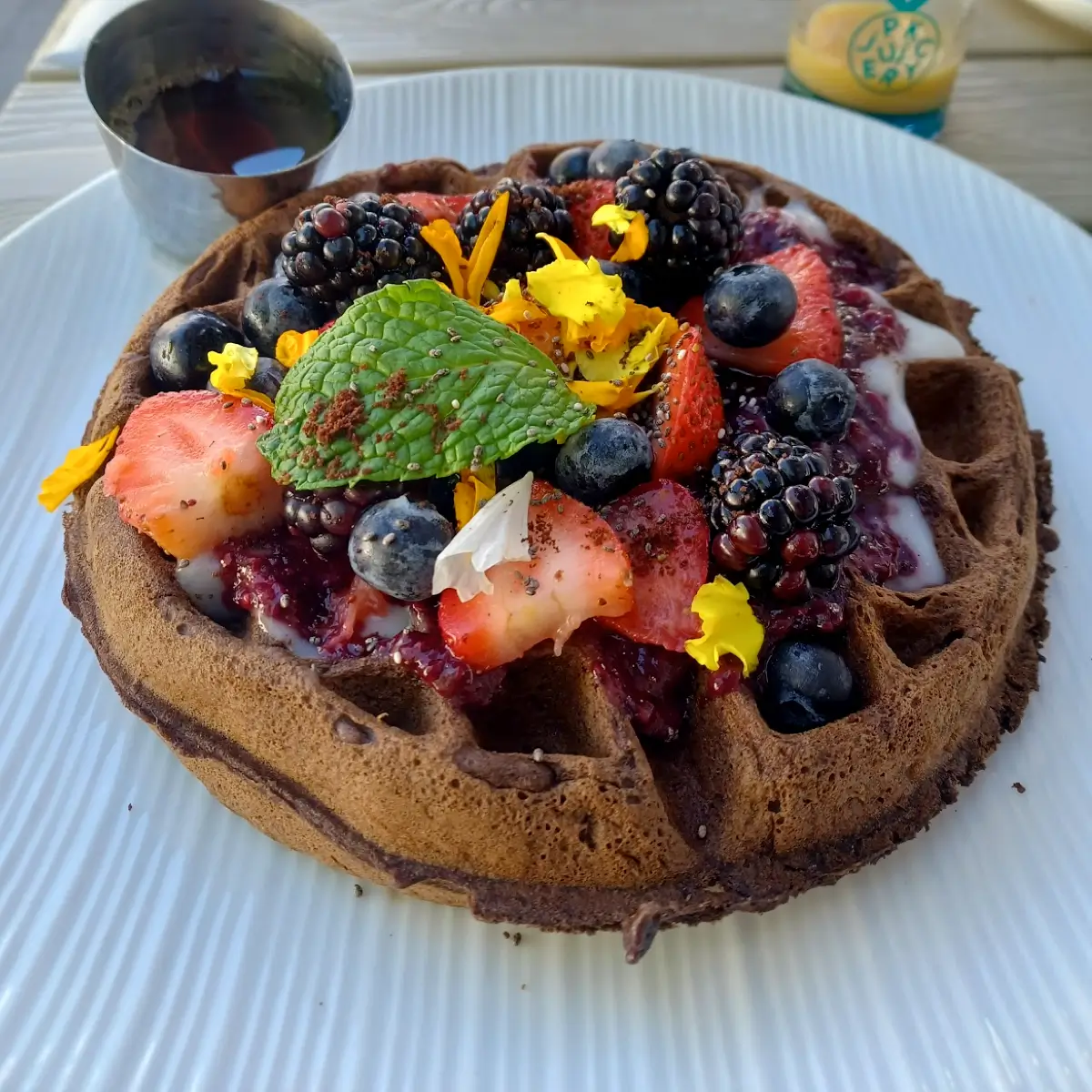 A round fruit waffle with sauce at Parakeet Cafe.