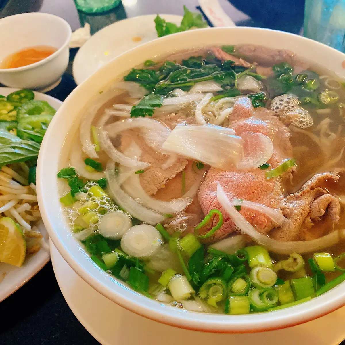 A hot bowl of beef pho with condiments from 
Phở Fifth Avenue.