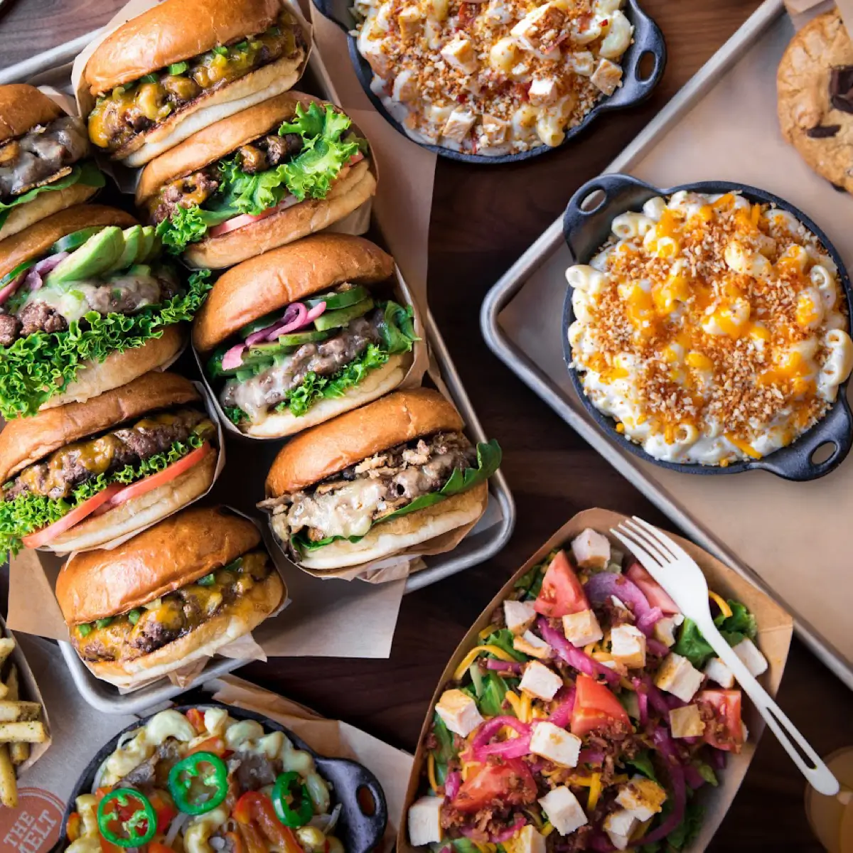 A variety of burgers, salads, and mac and cheese from The Melt